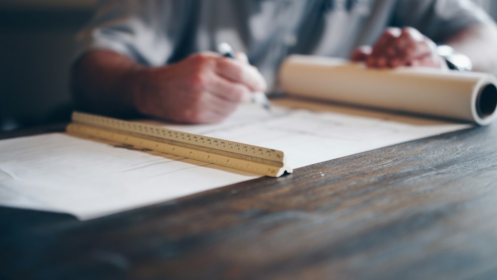 An architect drafting a plan by hand